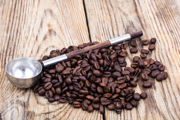 Bunch of coffee beans on wooden table