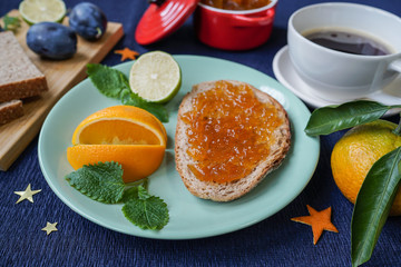 New Year's breakfast, coffee, bread, jam. Festive table setting.