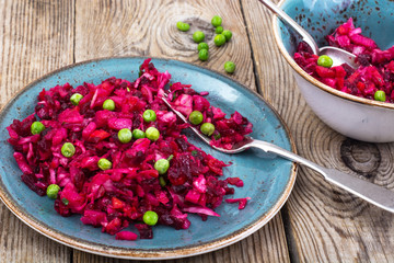 Vinaigrette salad with beets, potatoes, carrots and peas