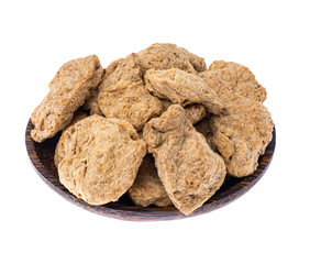 Dry soy slices of meat in wooden plate on white background