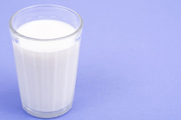 Glass with milk on bright background