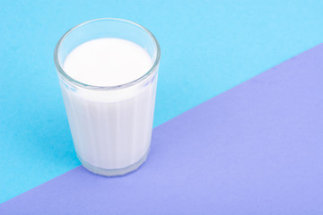 Glass with milk on bright background