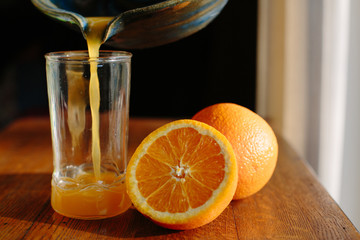pouring a glass of fresh squeezed orange juice