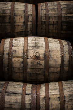 Wooden barrels and casks sit in a pile