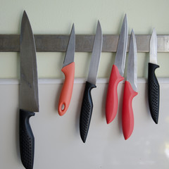 Noże wiszące w kuchni na listwie magnetycznej. - obrazy, fototapety, plakaty