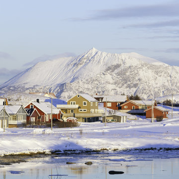View of village against snowcapped mountain