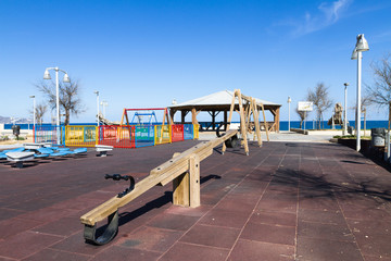 Children's safe wooden playground recreation area at seaside public park