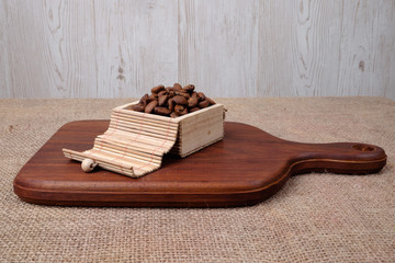 Coffee beans on wooden cutting board . Relax time concept.