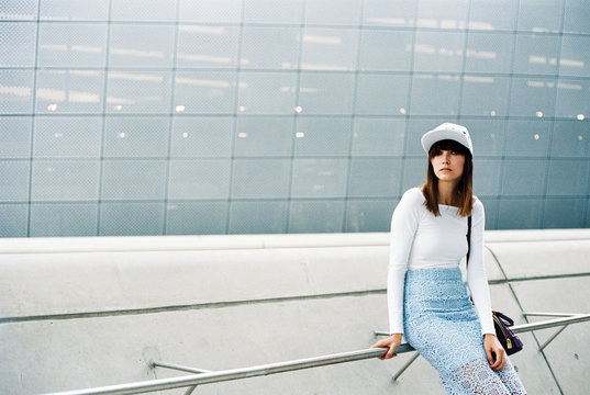 Portrait of a woman sitting on rails