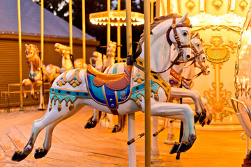 Illuminated retro carousel at night