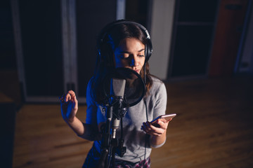 Singer recording song for her album in studio