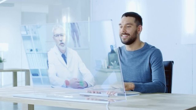 In the Near Future Stylish Man Takes Urgent Call from His Doctor, They Talk Over Computer with Transparent Display. His House is Modern and Bright.  Shot on RED EPIC-W 8K Helium Cinema Camera.