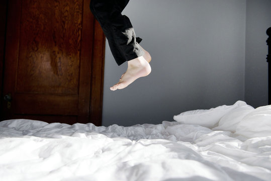 Child jumps on bed