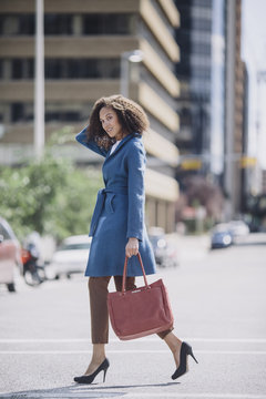 A business woman crossing the street