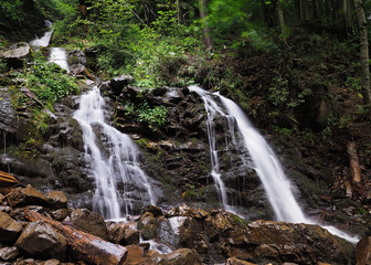 Naklejka na ściany i meble Waterfall at the carpatian mountains green forest