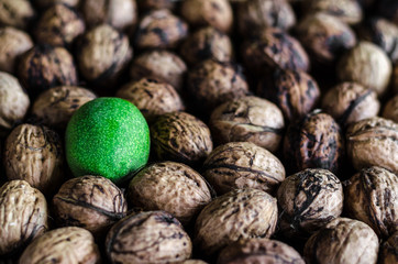 a lot of textured peeled walnuts and one green