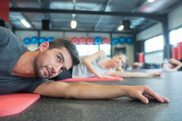 Fototapeta premium group of people doing stretching after workout