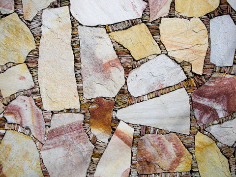 A mosaic of coloured stonework of various colours
