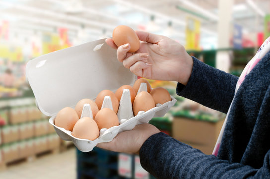 Woman buys eggs in the supermarket