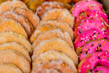 Donuts arranged in a row on the tray.
