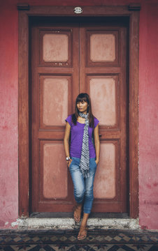 Woman Posing in Front of a Red Door