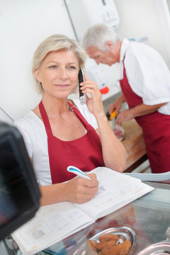 Butcher couple ordering stock