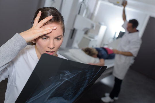 Nurse looking at xray with shocked expression