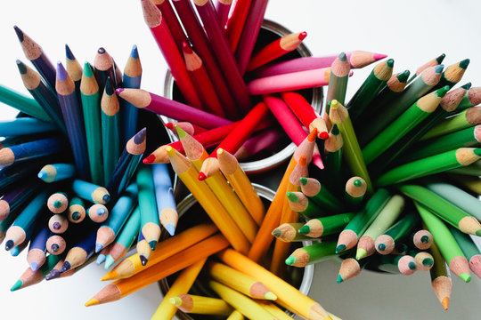 bright colored pencils in containers