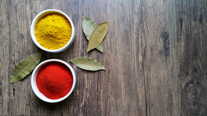 Colorau and saffron in white glass bowl on wooden background