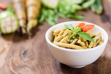 Northern Thai food (Yum Nor Mai),spicy bamboo shoot salad with crab paste on wooden background