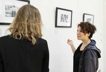 People looking at frames in exhibition