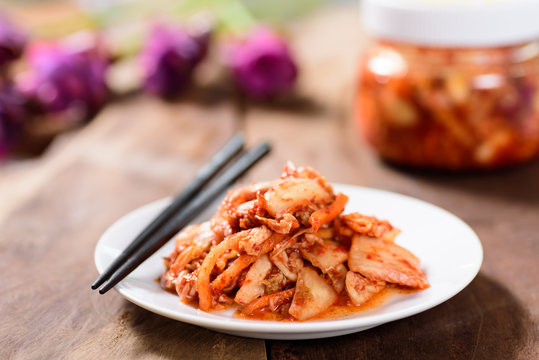Korean food, kimchi cabbage on white dish with chopsticks for eating.Healthy food