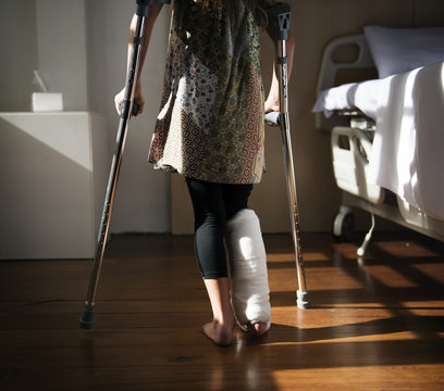 Young Caucasian Girl With Broken Leg In Plaster Cast