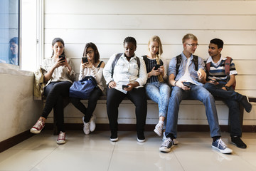 Group of diverse students using mobile phones