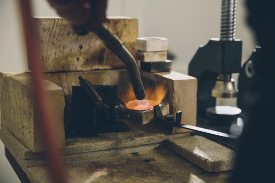 Closeup of a jewelry designer melting silver