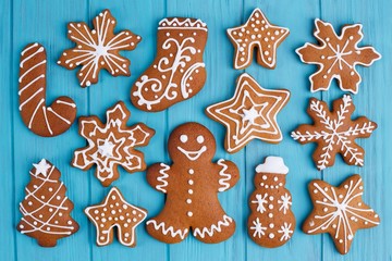 Christmas background. Gingerbread cookies set on blue table, flat lay. Christmas and New year traditions, winter holidays, homemade sweets, festive food