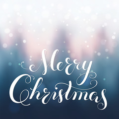 Merry Christmas greeting card. Modern calligraphy lettering. Bokeh background, blurred snowed forest.