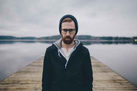 A Portrait Of A Man Standing On A Dock