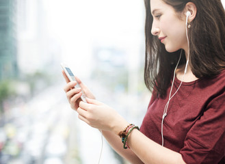 Young woman playing on her phone