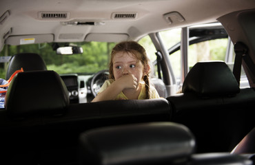 Fototapeta na wymiar Young caucasian girl sitting thoughtful inside the car