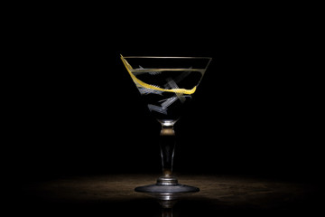 Transparent cocktail with lemon peel