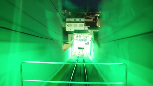 POV first person view hyperlapse of funicular railway in Nazare, Central Portugal. Ascensor of Nazare leading down from scenic overlook of Nazare Sitio to lower town at night.