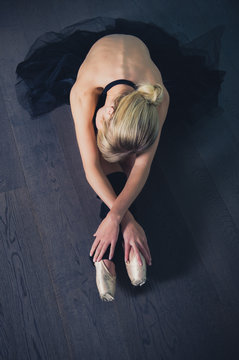 Ballerina stretching on the floor