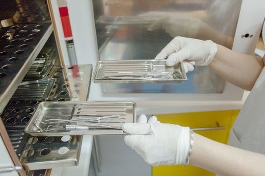 Dentist sterilizing the instruments.
