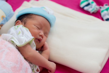 baby sleeping on bed