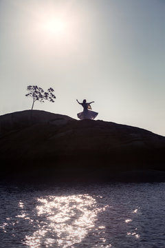 Woman Dancing by the Ocean