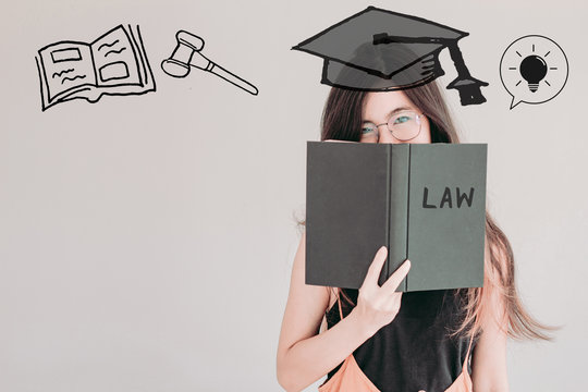 .Young asian Student woman holding book with law school doodles and copy space