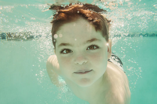 Young Boy Swimming Underwater