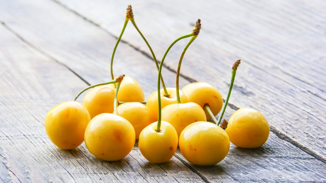 Yellow cherry on a wooden table