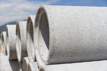 Precast concrete manholes are stored on the ground ready for construction
